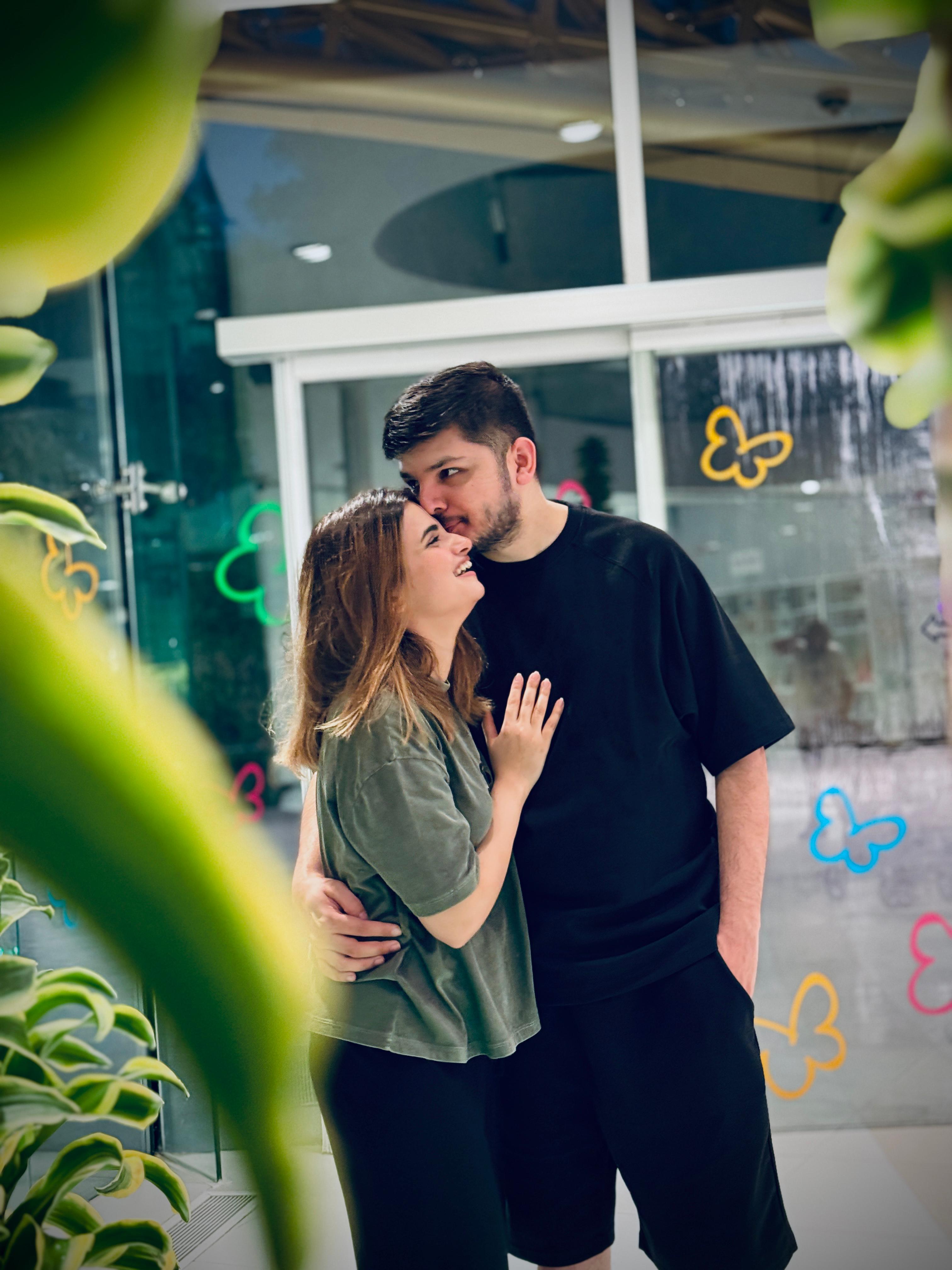 Sunny and Ayesha smiling close together