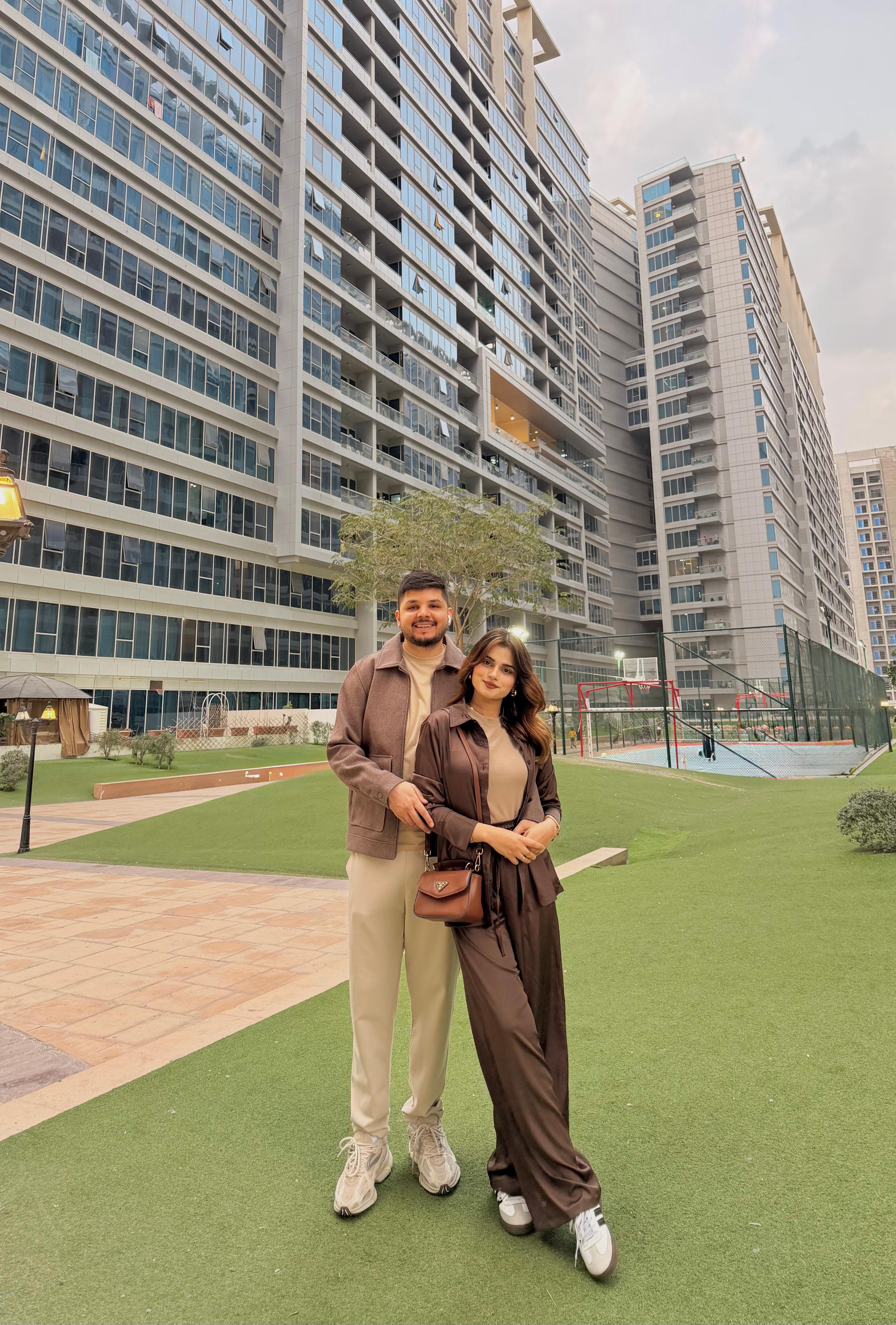 Sunny and Ayesha in tender embrace through leaves