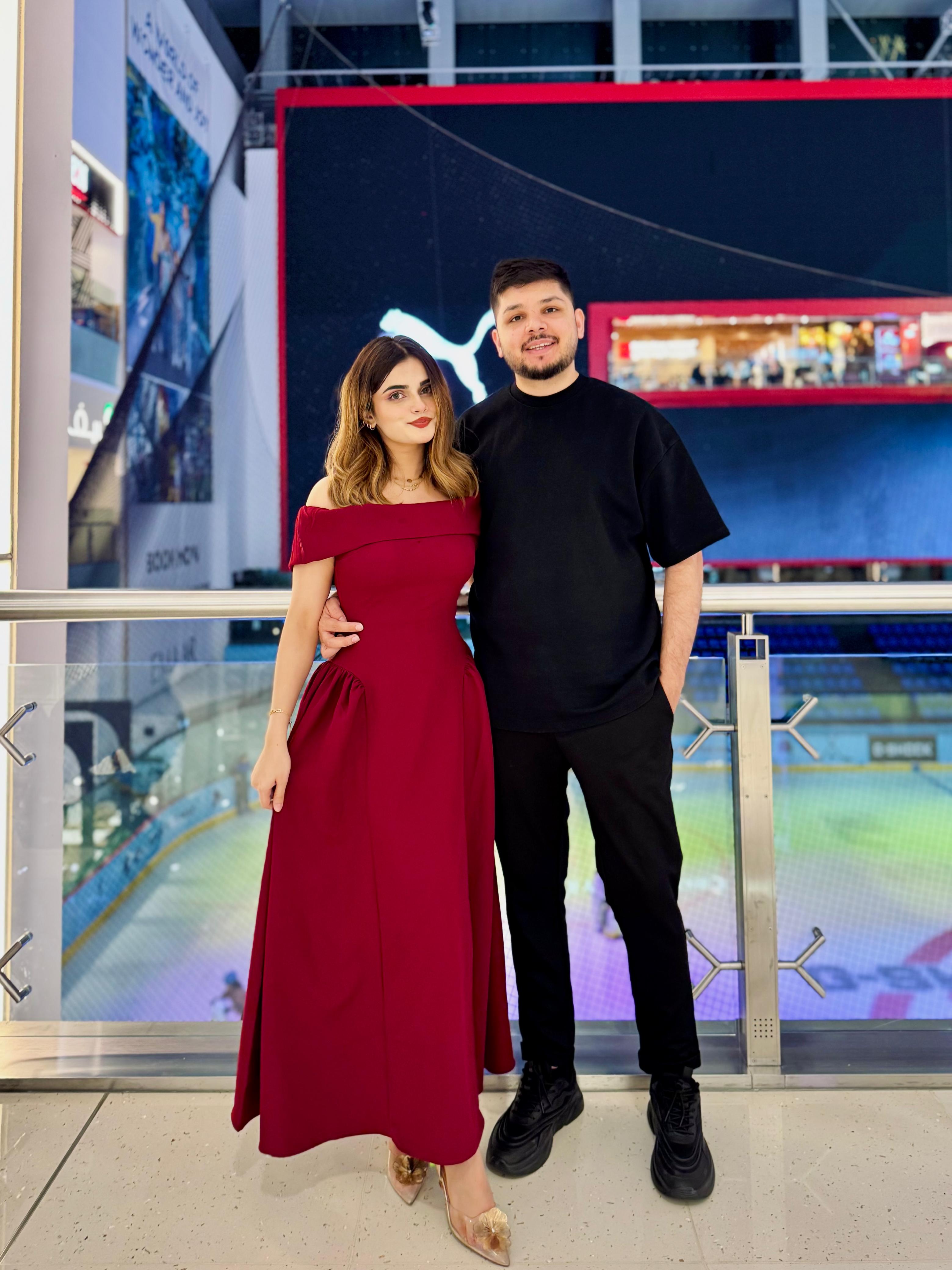 Sunny holding Ayesha close, dressed up