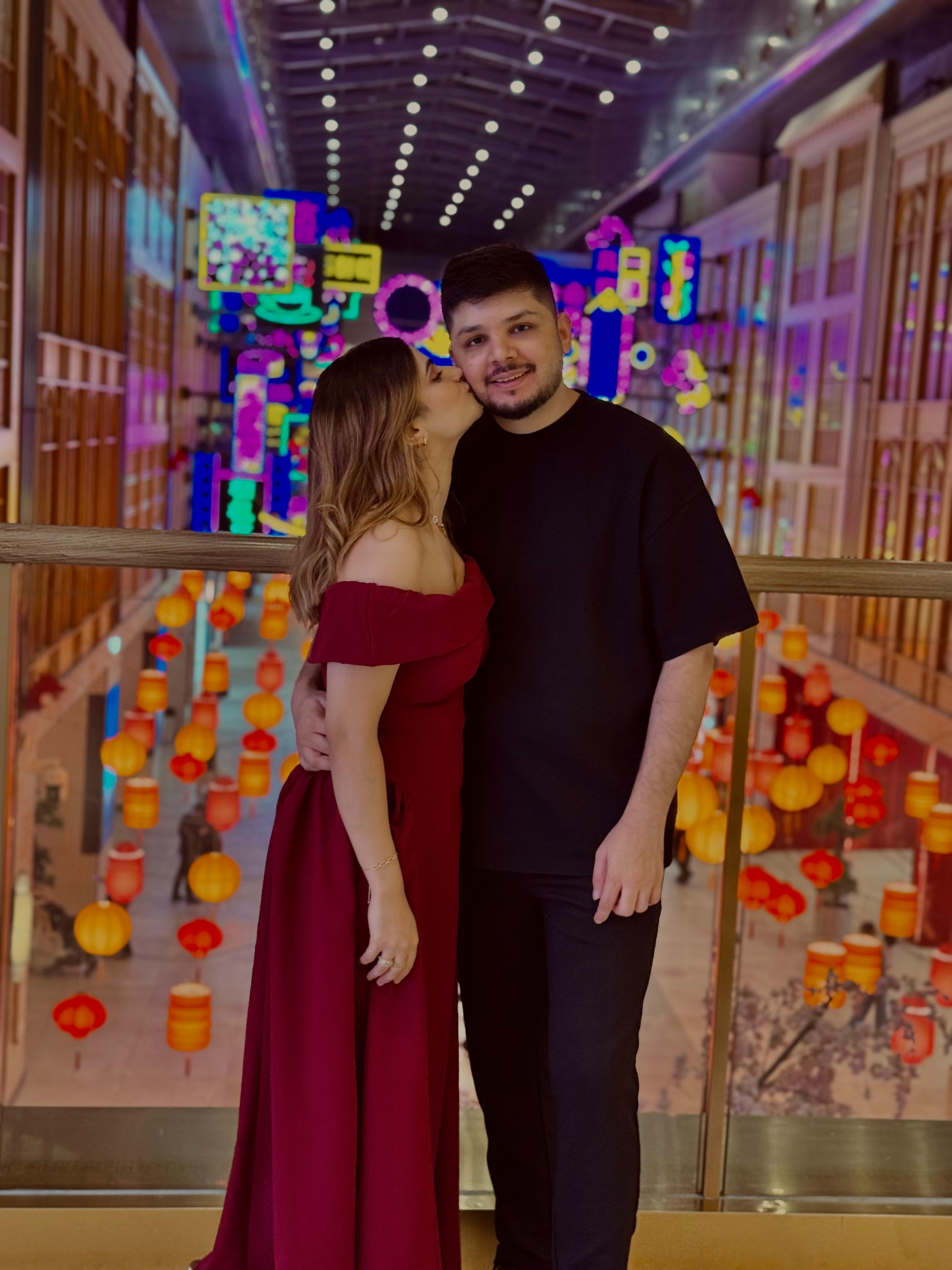 Sunny and Ayesha smiling with colorful lanterns