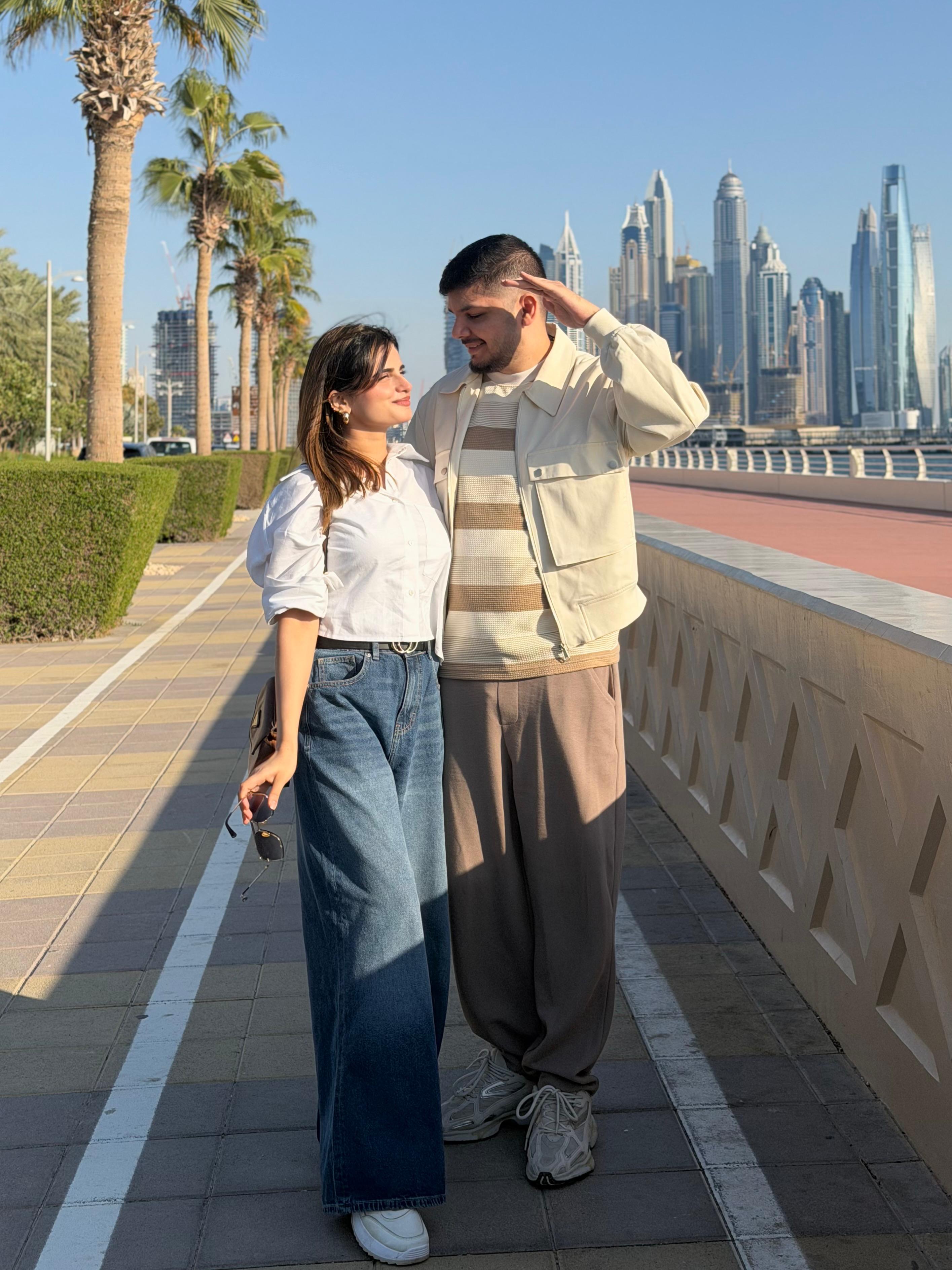 Sunny and Ayesha walking together outdoors