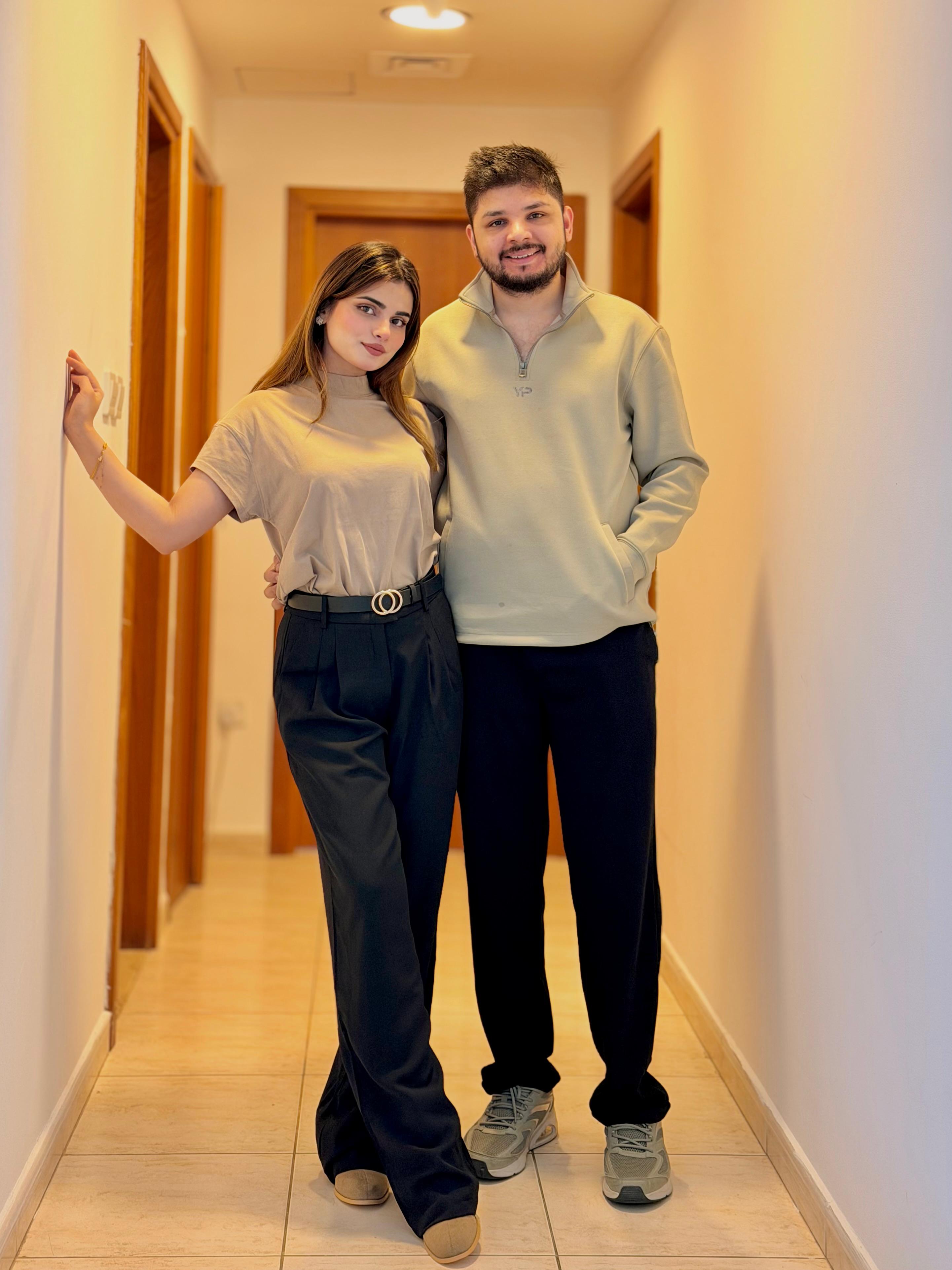 Sunny and Ayesha posing playfully on beach
