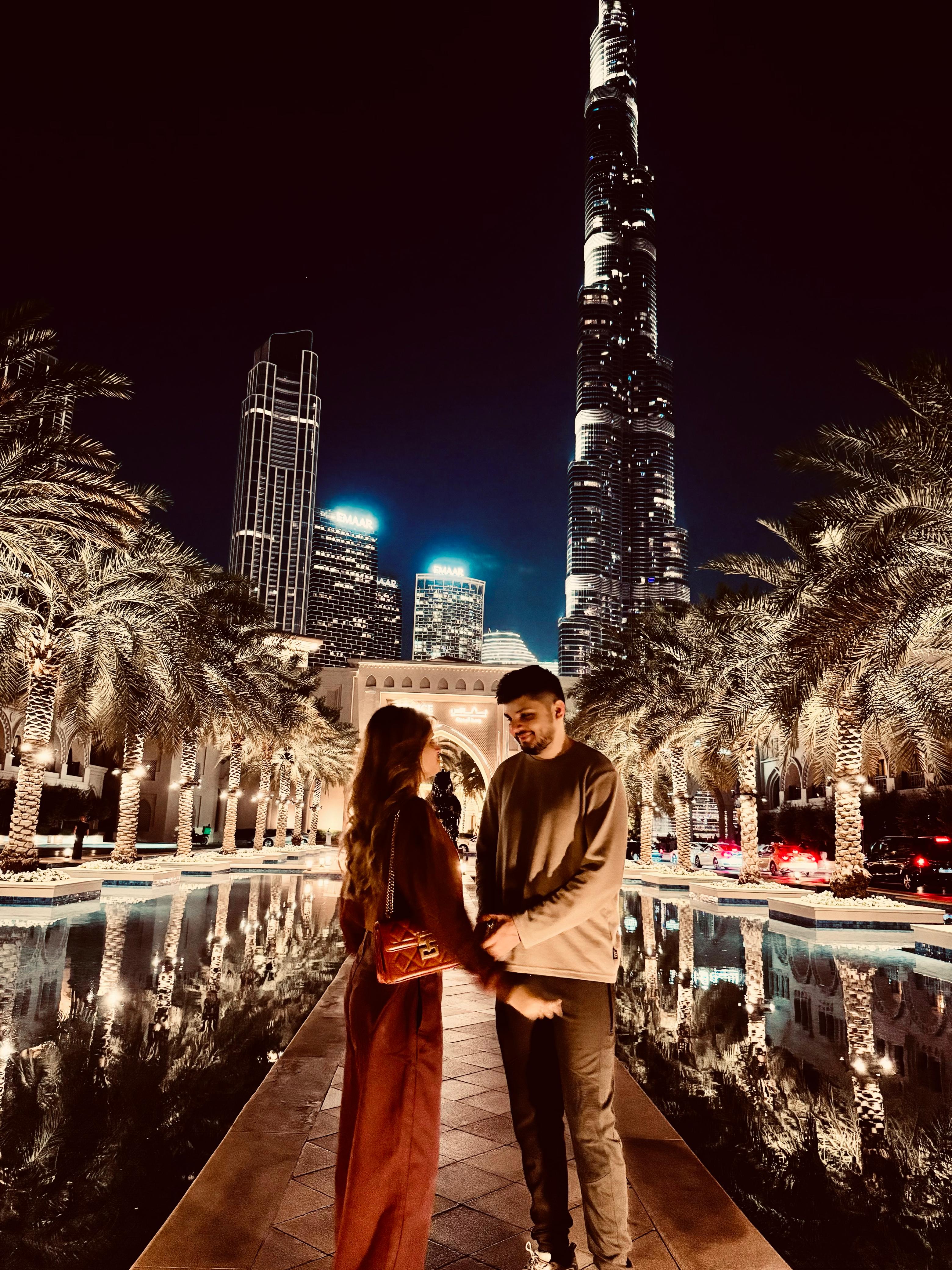 Sunny and Ayesha standing together in hallway